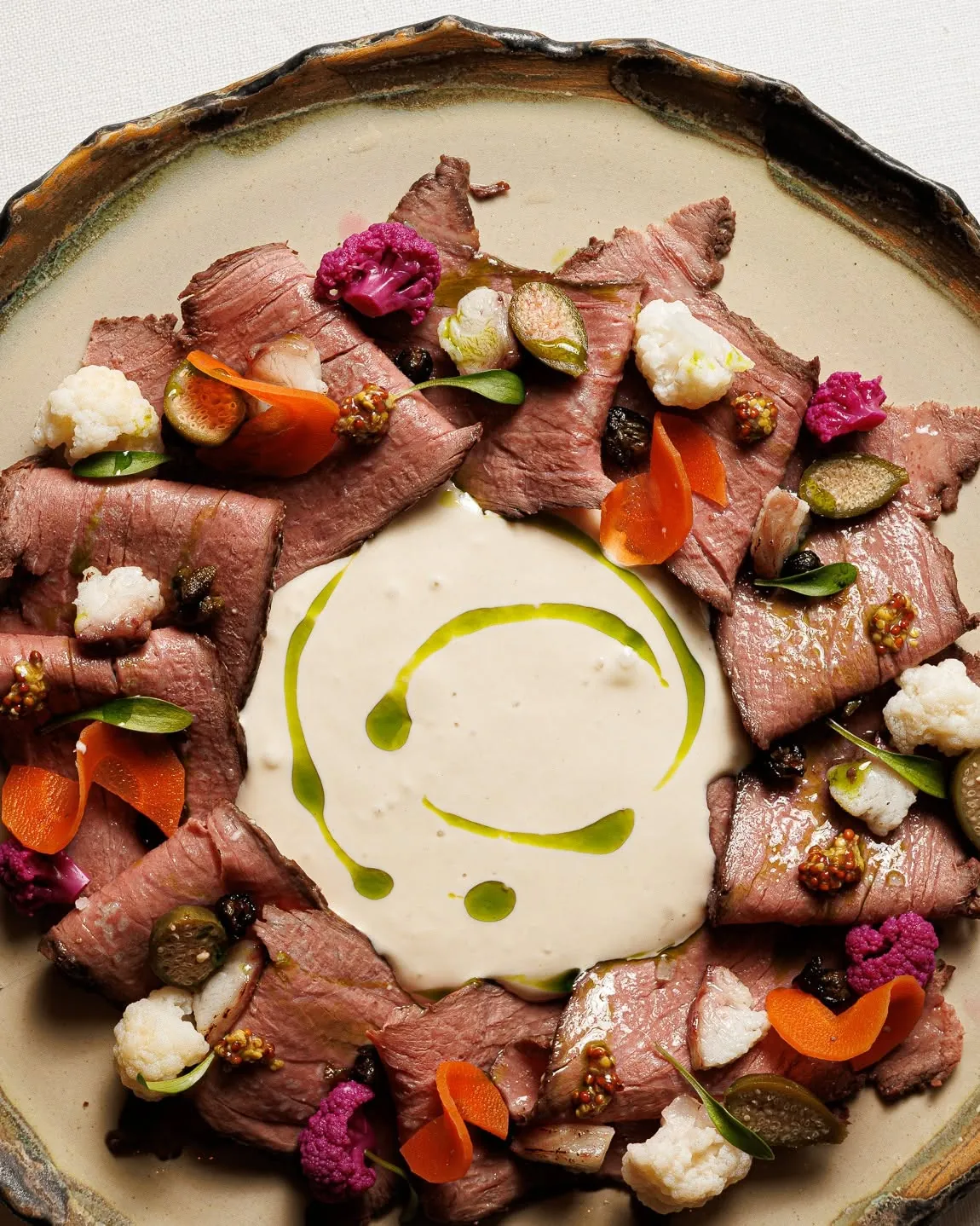 Carpaccio with a sauce of herbs and edible flowers