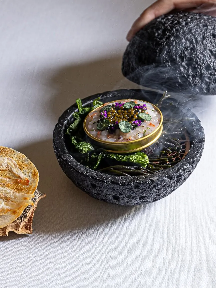 Caviar served in a smoking volcanic stone bowl