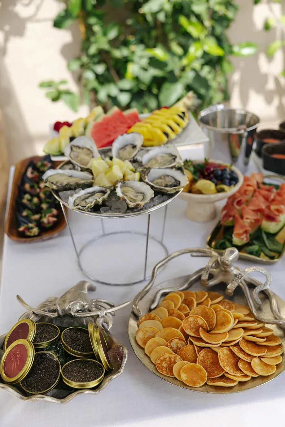 An event raw bar with oysters, caviar, blinis and fresh fruit