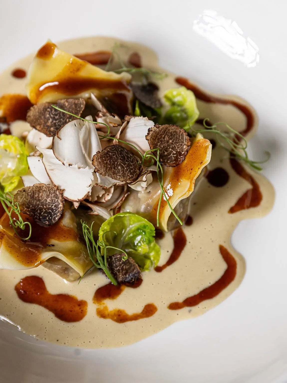 Pasta with shaved fresh truffle, mushrooms and brussels sprout leaves