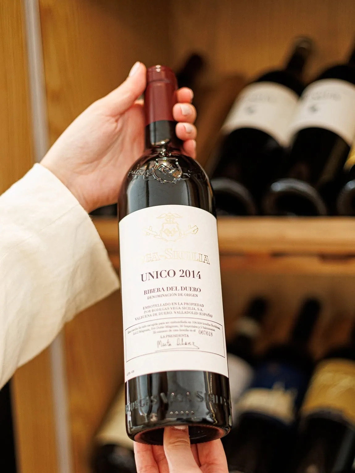 A bottle of Vega Sicilia Único 2014 presented in front of the cellar